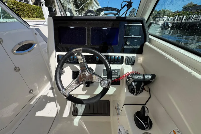  Yacht Photos Pics 2025 Sailfish 276 DC boat cockpit with steering wheel and control panel.