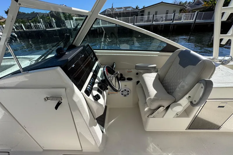  Yacht Photos Pics 2025 Sailfish 276 DC boat interior with steering wheel and comfortable seating.