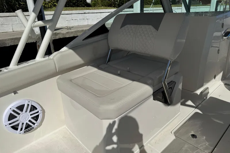  Yacht Photos Pics 2025 Sailfish 276 DC boat interior with cushioned seating and speaker.