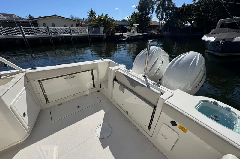  Yacht Photos Pics 2025 Sailfish 276 DC boat with Yamaha engines docked by waterfront homes.