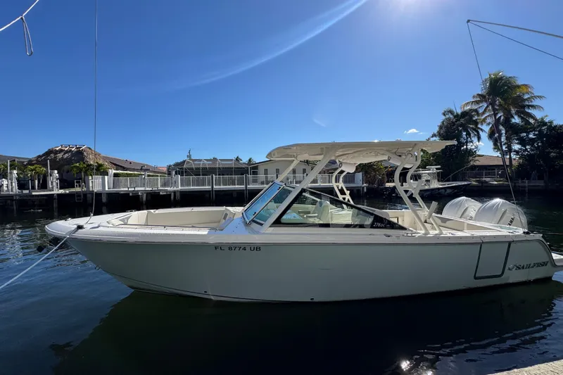  Yacht Photos Pics 2025 Sailfish 276 DC boat docked on a sunny day, showcasing sleek design and modern features.