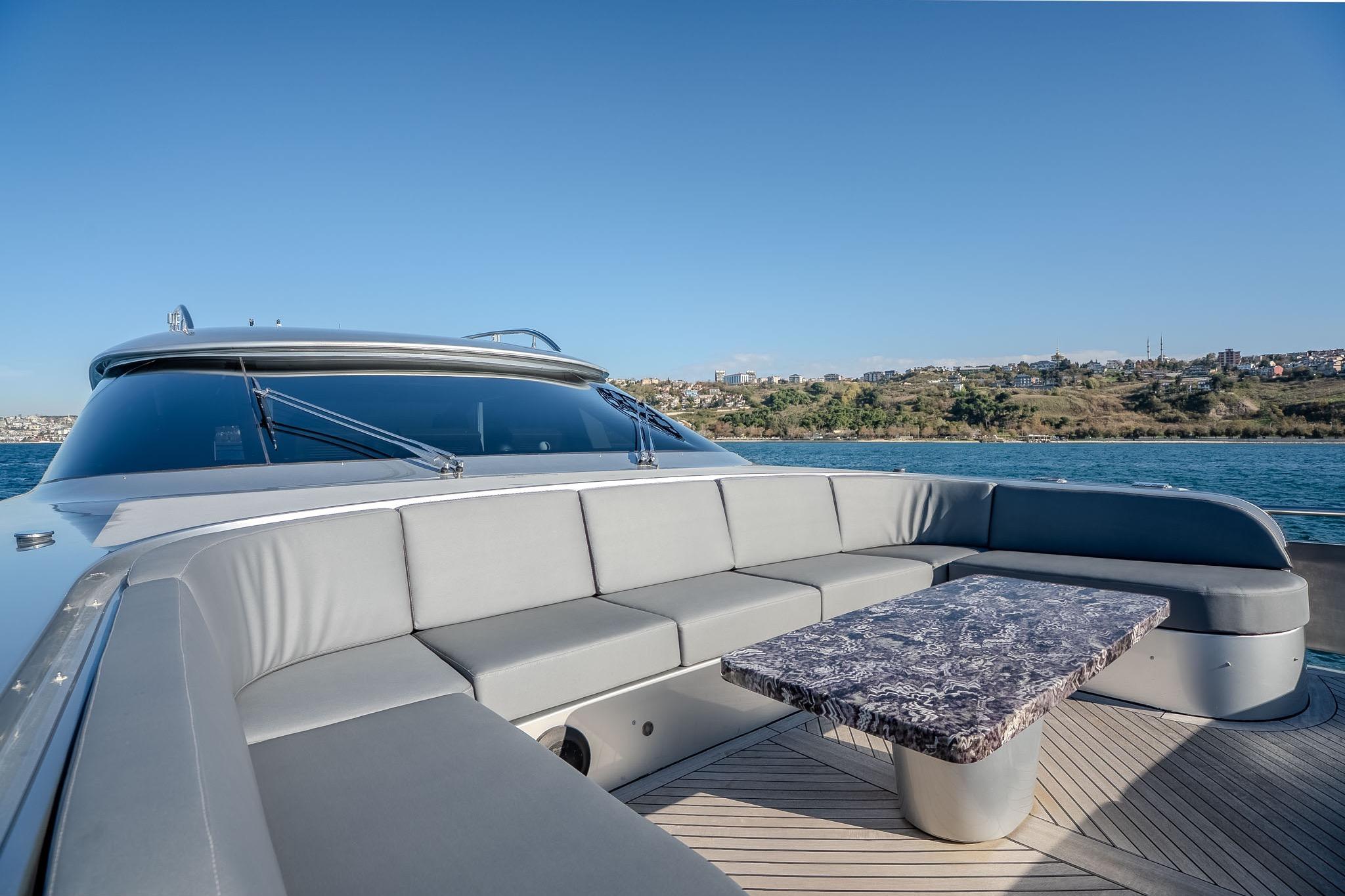 Luxurious 2016 Fipa Group AB 100 yacht with elegant outdoor seating and table.