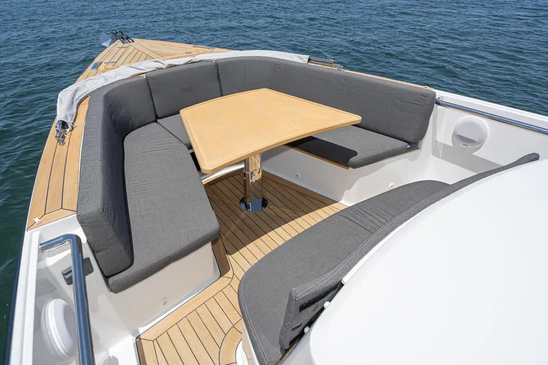 Intermezzo Yacht Photos Pics Luxurious seating area on 2018 Fjord 36 Xpress boat with wooden table and cushions.