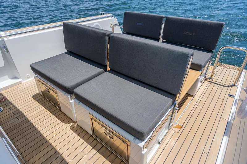 Intermezzo Yacht Photos Pics 2018 Fjord 36 Xpress boat with sleek seating on teak deck, ocean backdrop.