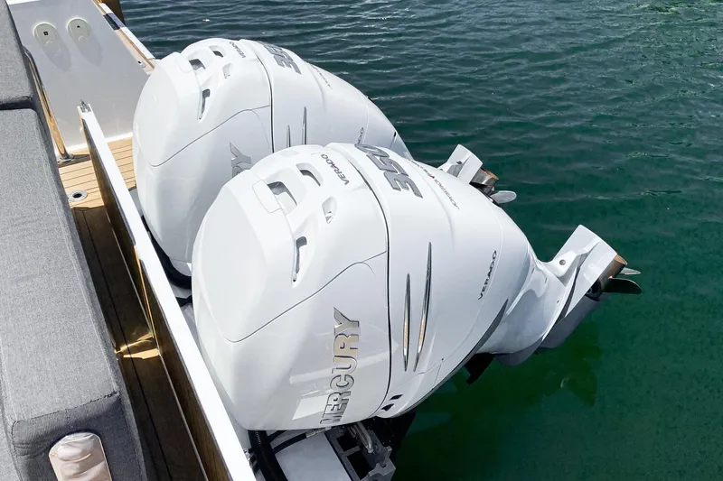Intermezzo Yacht Photos Pics Twin Mercury outboard engines on a 2018 Fjord 36 Xpress boat, docked on water.