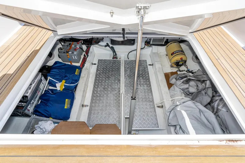 Intermezzo Yacht Photos Pics Open storage compartment of 2018 Fjord 36 Xpress boat, showing equipment and supplies.