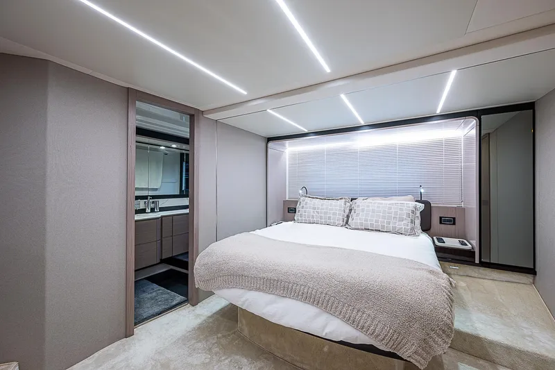 Evado Yacht Photos Pics Luxurious bedroom interior of 2020 Azimut 66 yacht with modern design and ambient lighting.