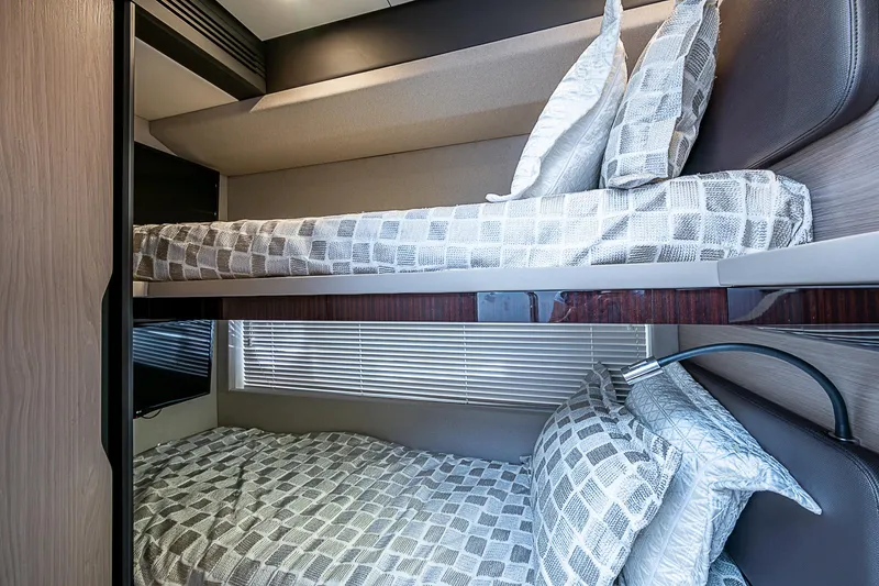 Evado Yacht Photos Pics Bunk beds in 2020 Azimut 66 yacht cabin with modern decor and patterned bedding.