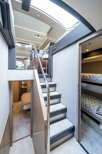 Evado Yacht Photos Pics Interior of 2020 Azimut 66 yacht, featuring modern stairs and cozy bunk beds.