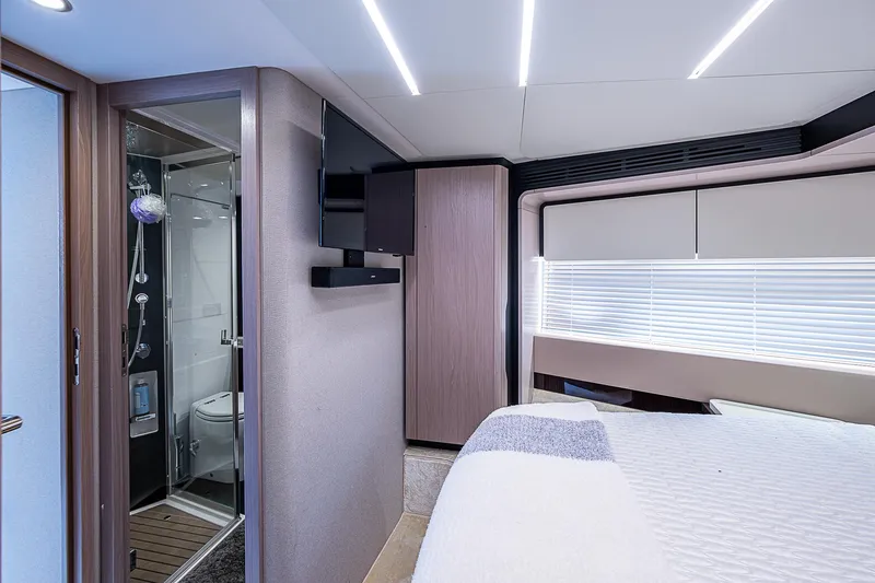Evado Yacht Photos Pics Luxurious interior of 2020 Azimut 66 yacht featuring modern bedroom and sleek bathroom.
