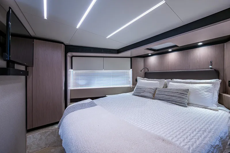Evado Yacht Photos Pics Luxurious bedroom interior of 2020 Azimut 66 yacht with modern lighting and elegant bedding.