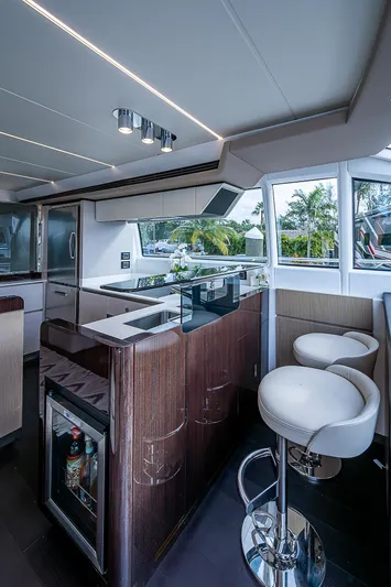 Evado Yacht Photos Pics Luxurious interior of 2020 Azimut 66 yacht with modern kitchen and seating.