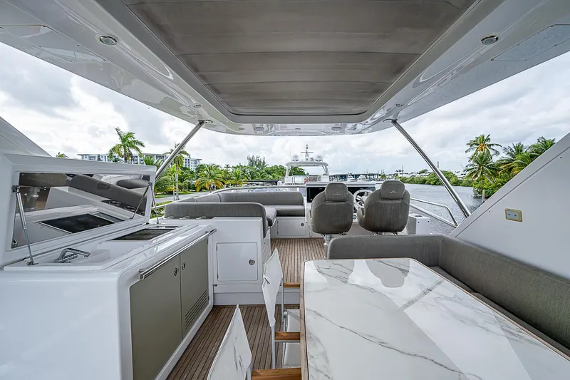 Evado Yacht Photos Pics Luxurious 2020 Azimut 66 yacht interior with modern seating and dining area.