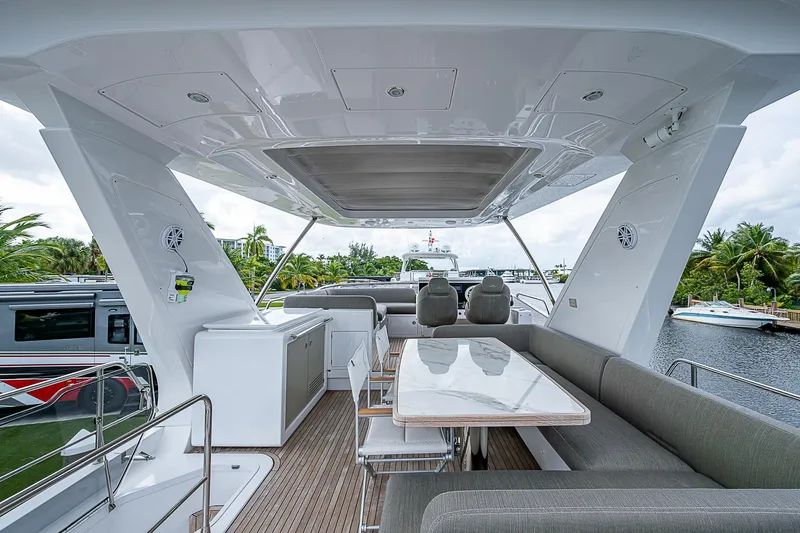 Evado Yacht Photos Pics Luxurious 2020 Azimut 66 yacht deck with seating and dining area.