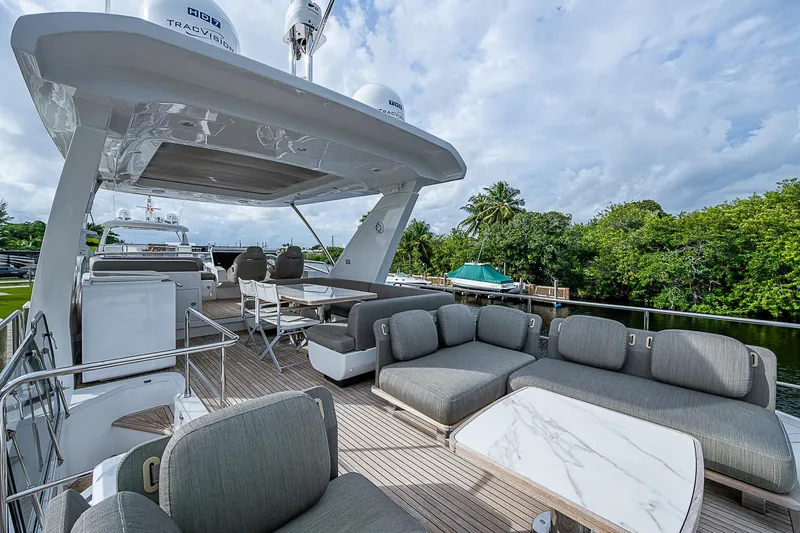 Evado Yacht Photos Pics Luxurious 2020 Azimut 66 yacht deck with plush seating and scenic view.