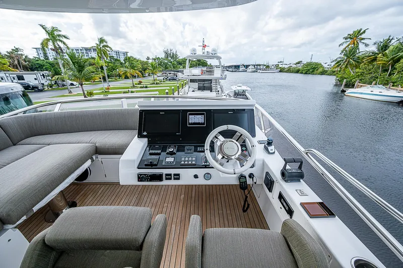 Evado Yacht Photos Pics Luxurious 2020 Azimut 66 yacht helm with plush seating and scenic waterway view.