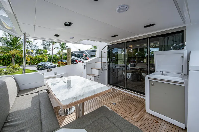 Evado Yacht Photos Pics Luxurious 2020 Azimut 66 yacht interior with modern seating and dining area.