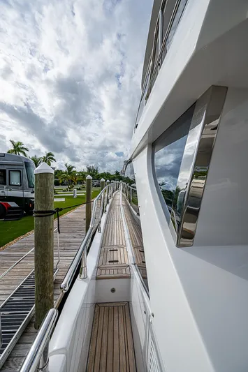 Evado Yacht Photos Pics Side view of 2020 Azimut 66 yacht docked under cloudy skies.