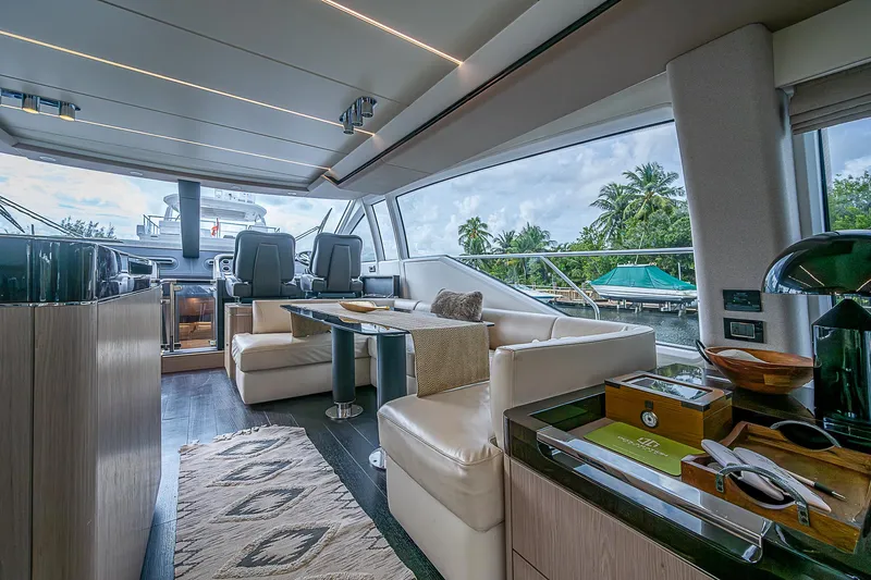 Evado Yacht Photos Pics Luxurious interior of 2020 Azimut 66 yacht with elegant seating and panoramic windows.