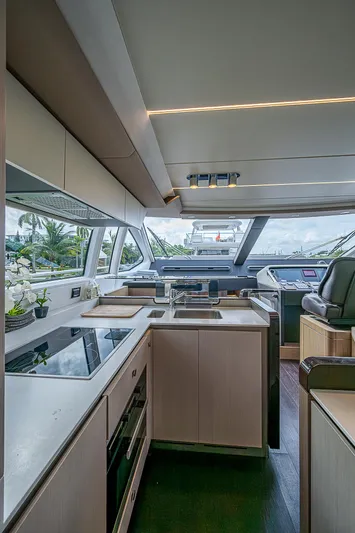 Evado Yacht Photos Pics Luxurious interior of 2020 Azimut 66 yacht with modern kitchen and helm.