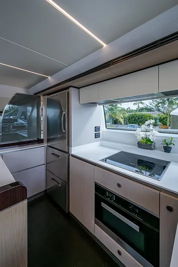 Evado Yacht Photos Pics Modern kitchen interior on 2020 Azimut 66 yacht with sleek appliances and window view.
