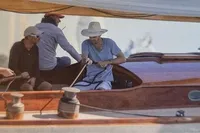 Sailors maneuvering a 1905 PLYMS PROTOTYPE SLOOP on open water.