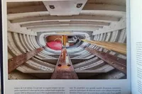 Interior view of 1905 PLYMS PROTOTYPE SLOOP, showcasing wooden beams and structural details.