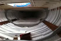 Interior view of 1905 PLYMS PROTOTYPE SLOOP, showcasing wooden hull structure.