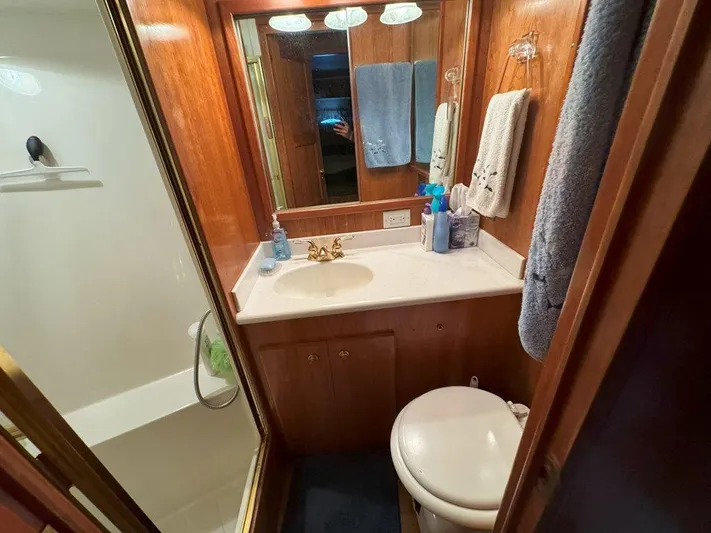  Yacht Photos Pics Compact bathroom in 2003 Navigator 4800 yacht with wood accents and shower.