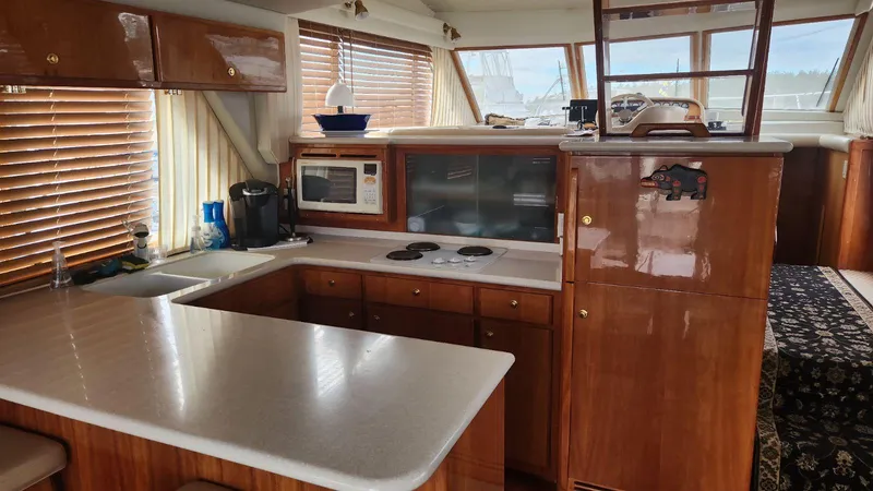  Yacht Photos Pics Luxurious 2003 Navigator 4800 yacht kitchen with wood cabinetry and modern appliances.