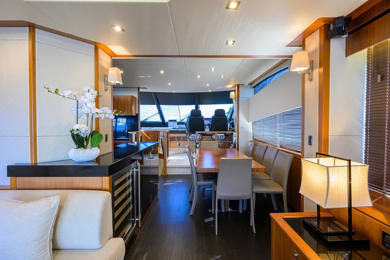 Catch The Wave Yacht Photos Pics Luxurious interior of 2014 Sunseeker Manhattan 73 yacht with elegant dining area.