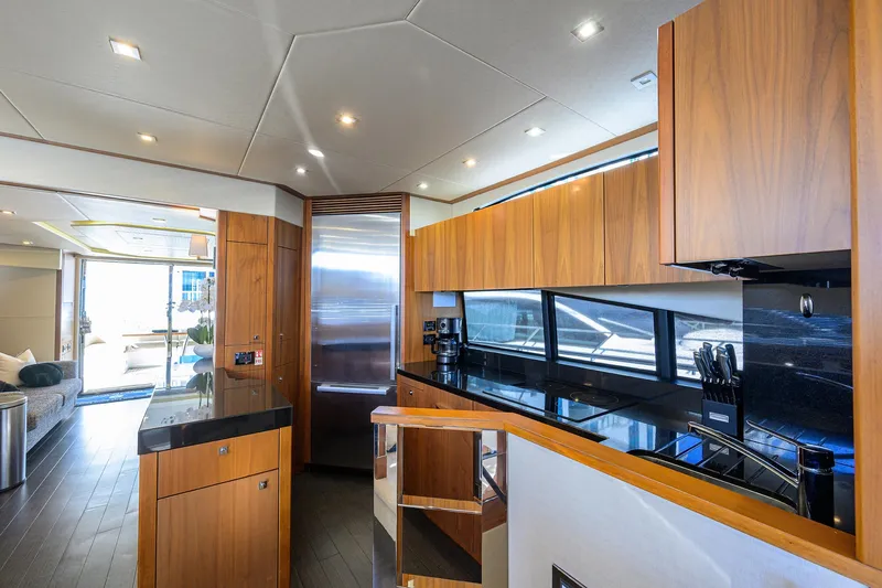 Catch The Wave Yacht Photos Pics Luxurious interior of 2014 Sunseeker Manhattan 73 yacht with modern kitchen design.