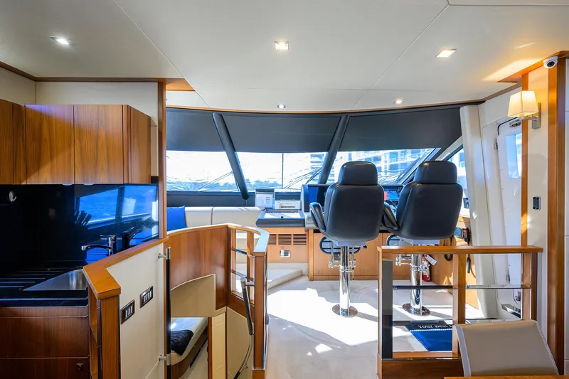 Catch The Wave Yacht Photos Pics Interior of 2014 Sunseeker Manhattan 73 yacht, featuring helm and luxurious seating.