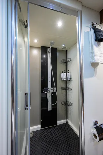 Catch The Wave Yacht Photos Pics Shower area in 2014 Sunseeker Manhattan 73 yacht, featuring modern fixtures and shelving.