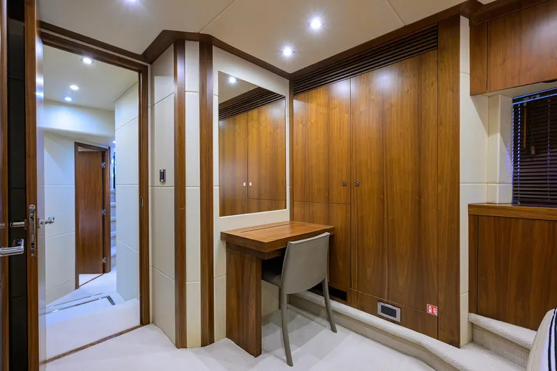 Catch The Wave Yacht Photos Pics Luxurious interior of 2014 Sunseeker Manhattan 73 yacht with wooden cabinetry and seating area.