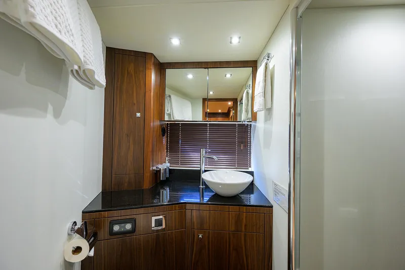 Catch The Wave Yacht Photos Pics Luxurious bathroom in 2014 Sunseeker Manhattan 73 yacht with modern fixtures and wood accents.