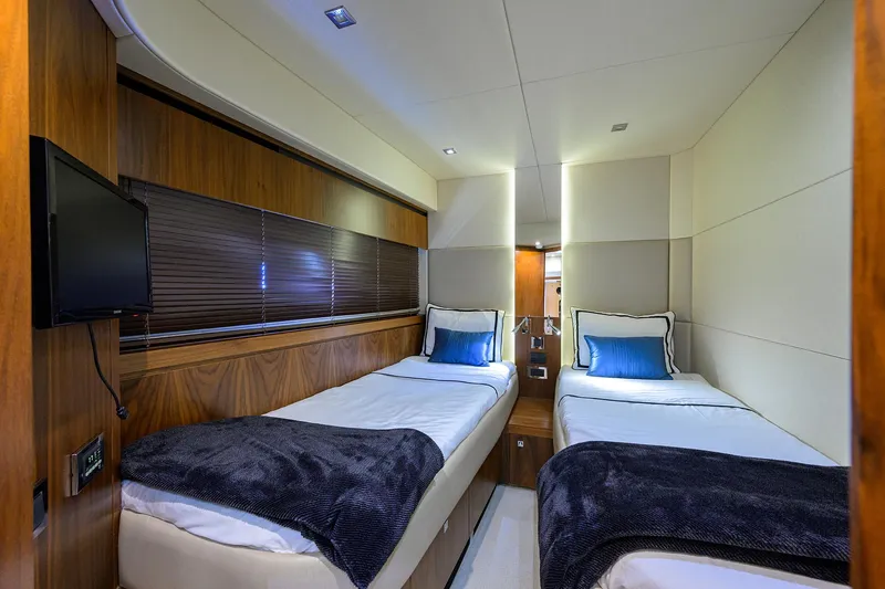 Catch The Wave Yacht Photos Pics Luxurious twin cabin in 2014 Sunseeker Manhattan 73 yacht, featuring modern decor and cozy bedding.