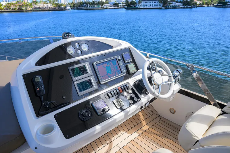 Catch The Wave Yacht Photos Pics Cockpit of 2014 Sunseeker Manhattan 73 yacht with navigation controls and steering wheel.