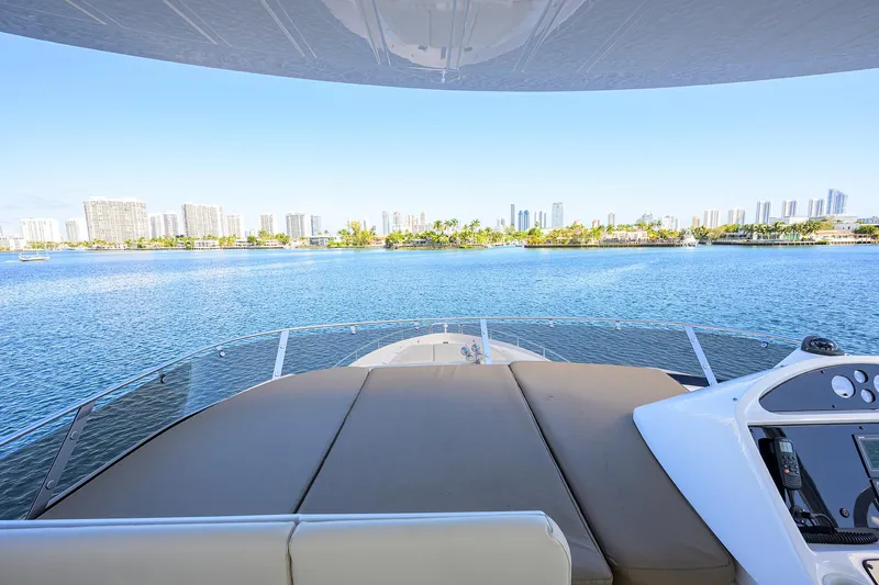 Catch The Wave Yacht Photos Pics 2014 Sunseeker Manhattan 73 yacht with city skyline view on calm water.