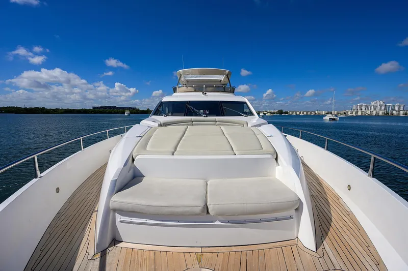Catch The Wave Yacht Photos Pics 2014 Sunseeker Manhattan 73 yacht on calm water, featuring spacious deck and luxurious seating.
