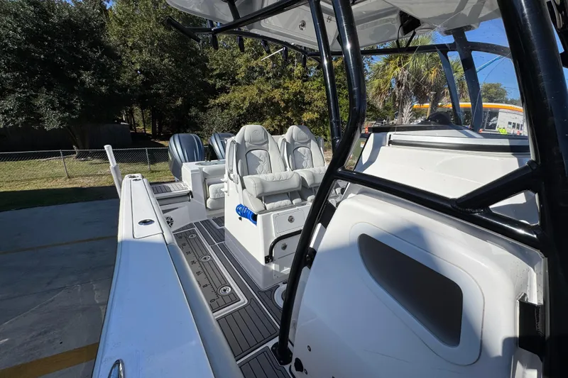  Yacht Photos Pics 2022 Sea Fox 288 Commander boat interior with seating and console, docked outdoors.