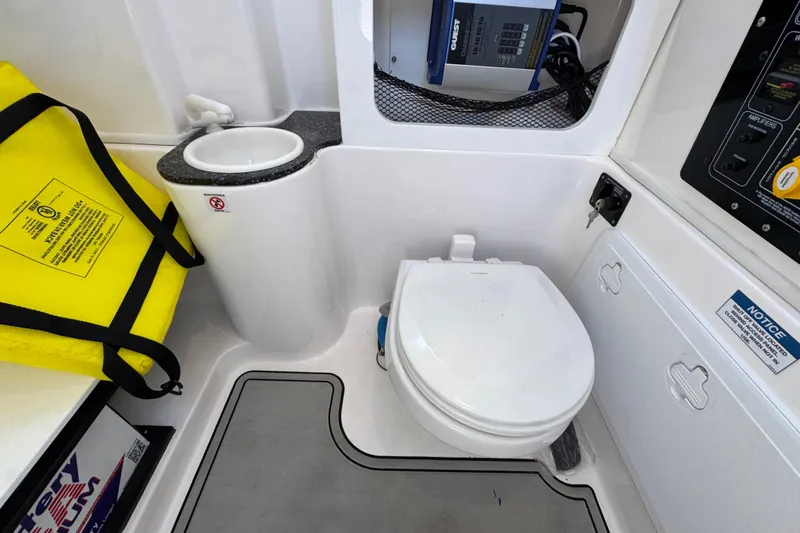  Yacht Photos Pics 2022 Sea Fox 288 Commander boat bathroom with toilet, sink, and safety equipment.