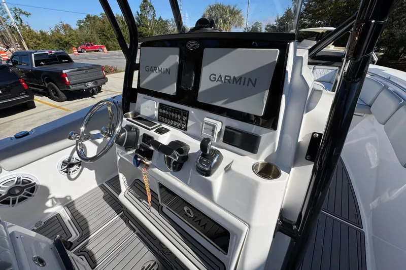  Yacht Photos Pics 2022 Sea Fox 288 Commander boat dashboard with Garmin navigation system and steering wheel.