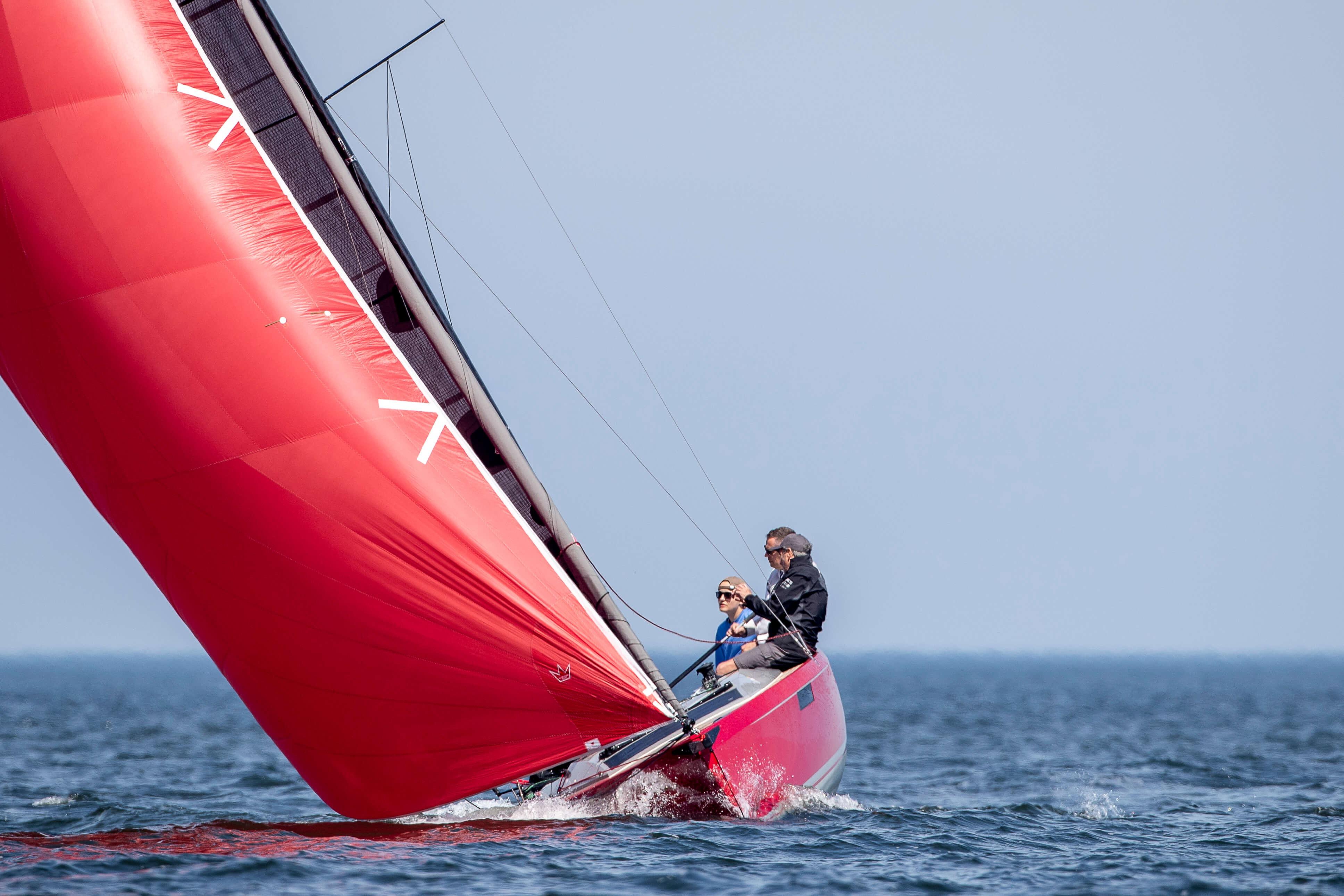 2024 Saffier SE 24 Lite sailboat with vibrant red sail on open water.