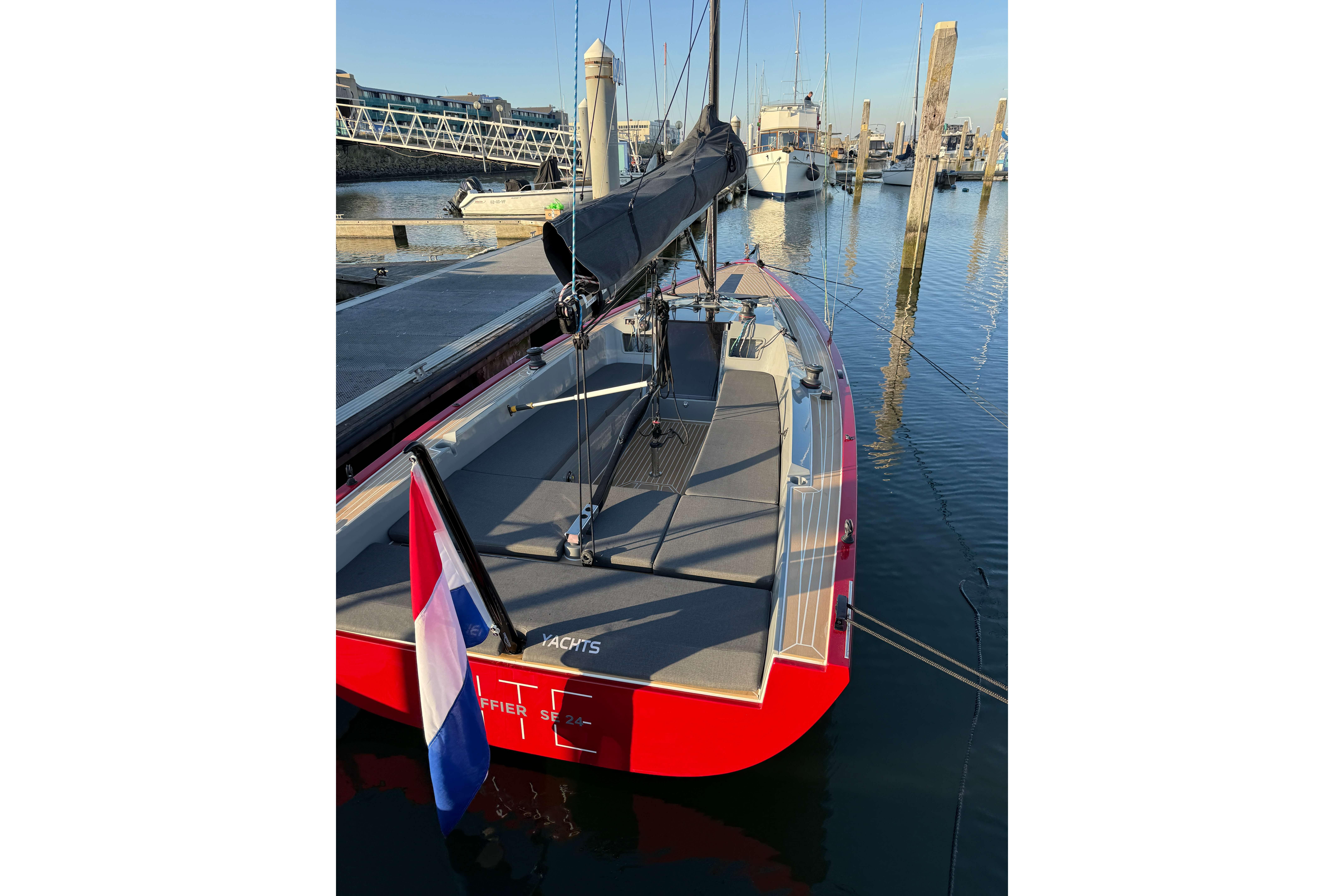 2024 Saffier SE 24 Lite sailboat docked, featuring sleek design and vibrant red hull.