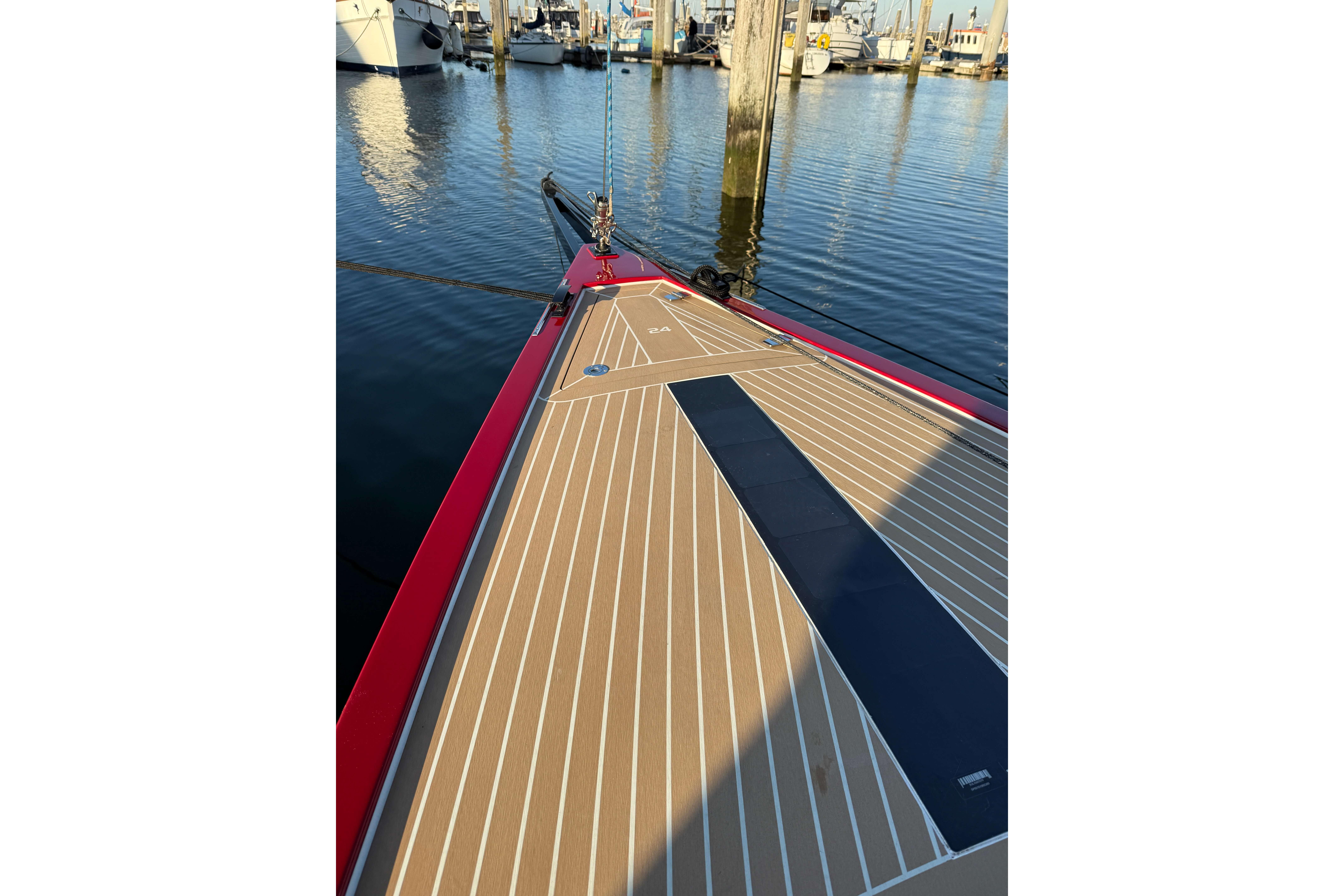 2024 Saffier SE 24 Lite sailboat deck at marina, featuring sleek design and wood finish.