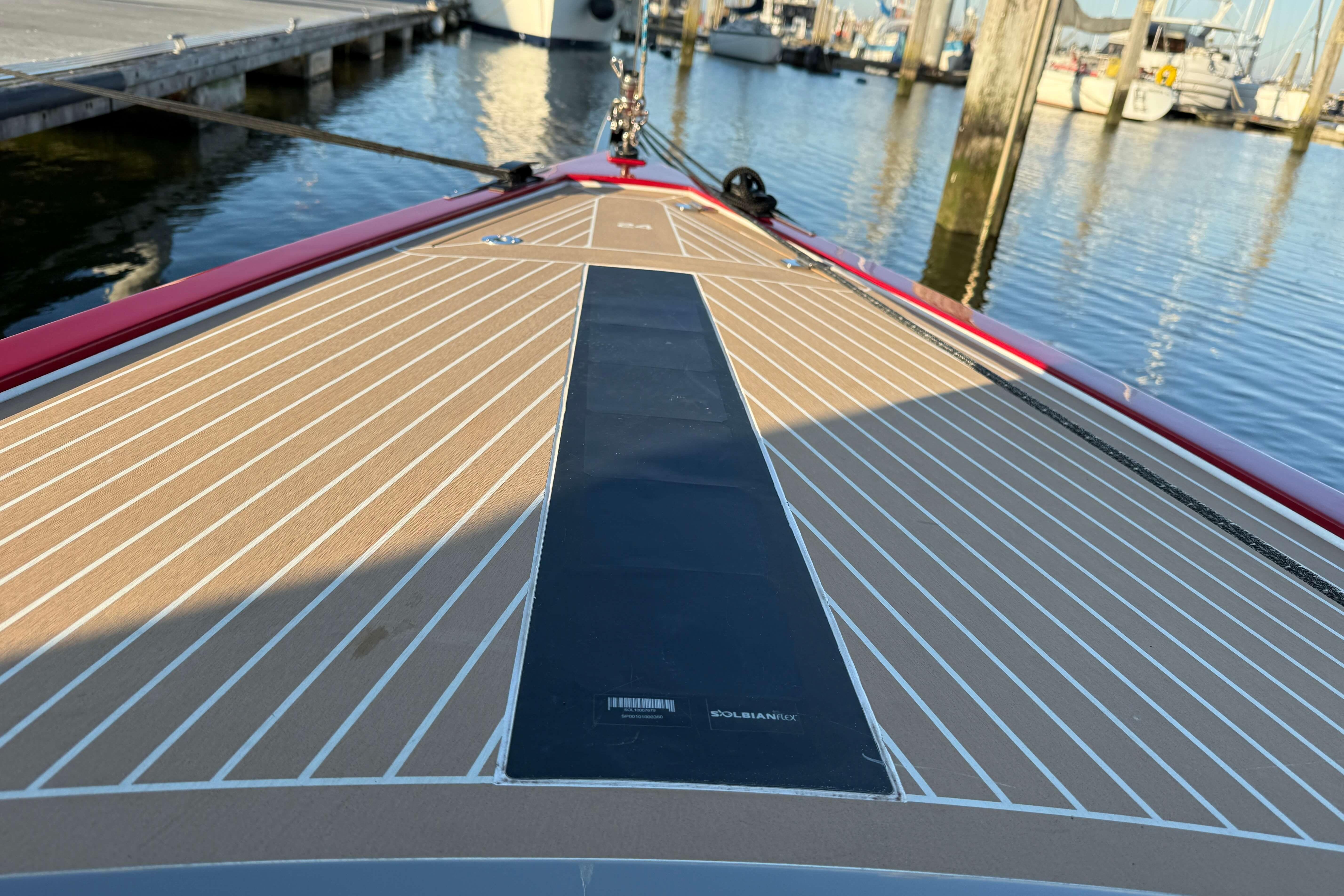 2024 Saffier SE 24 Lite sailboat deck at marina, featuring sleek design and wood finish.