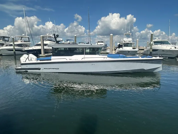 Empoleon Yacht Photos Pics 2025 Axopar 37XC CROSS CABIN BRABUS Trim boat docked in a marina under blue skies.
