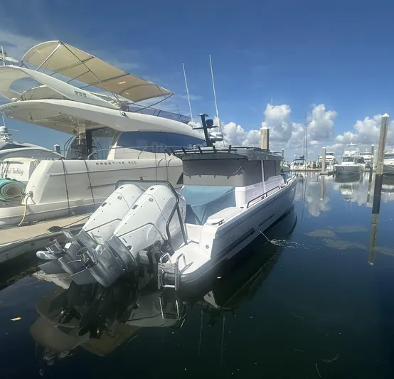 Empoleon Yacht Photos Pics 2025 Axopar 37XC CROSS CABIN BRABUS Trim docked at marina under clear blue sky.