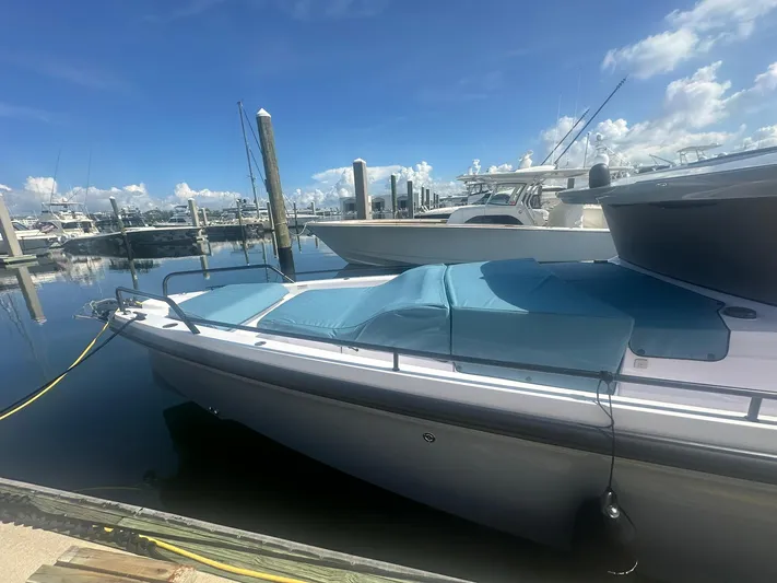 Empoleon Yacht Photos Pics 2025 Axopar 37XC CROSS CABIN BRABUS Trim boat docked at marina under clear blue sky.